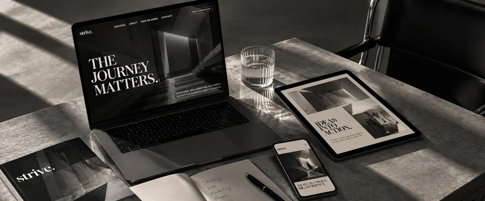 Strive website displayed across a creative workspace